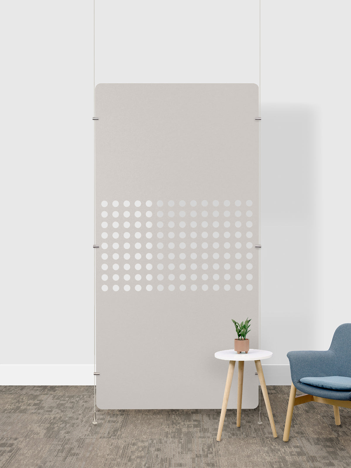 Tall beige room divider with white perforated circles in lower half, mounted on metal frame with anchoring brackets.