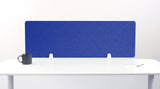 Blue desk divider with chevron quilted pattern mounted on white desk with support brackets.