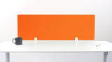 Orange desk divider with quilted chevron pattern mounted on white desk with supports.
