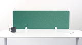 Teal desk divider with chevron pattern mounted on white desk with black mug and office supplies.