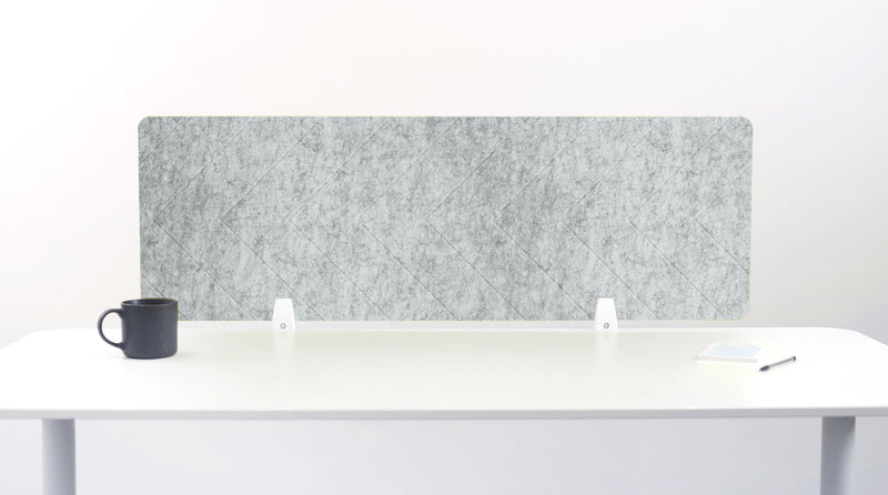 Gray acoustic panel on a white desk with a black mug