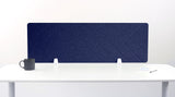 Navy blue desk divider with chevron quilted pattern mounted on white desk with two supports.