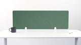 Green fabric desk divider with chevron quilting pattern mounted on white desk with metal brackets.