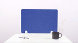 Blue desk divider with chevron pattern and white mounting brackets on white desk surface.