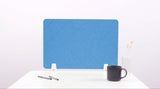 Blue desk divider with chevron pattern and white mounting brackets, positioned on white surface with office supplies.