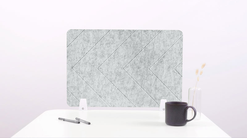Felt screen protector on a white surface with a pen and mug