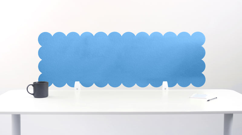 Blue scalloped office screen on a white desk with a white background