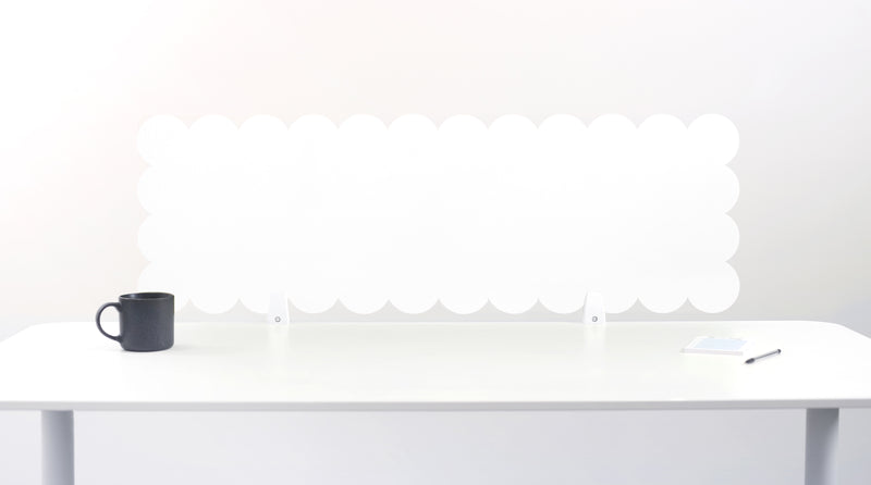 White desk with a black mug and white lamp on a white background