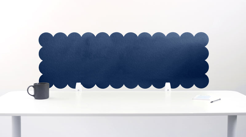 Scallop-shaped blue screen partition on a white desk with a mug and pen.