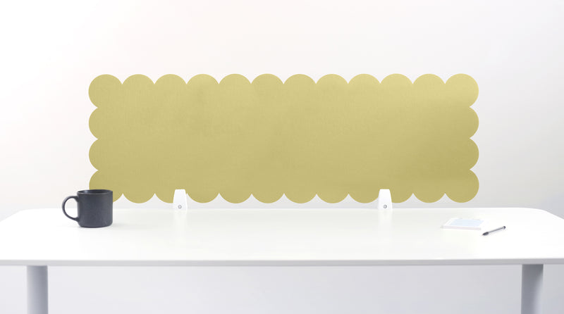 Scalloped gold screen on a white table with a white background