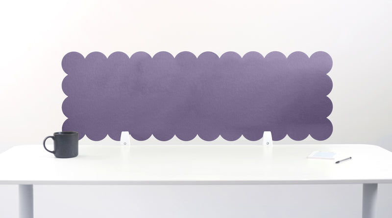 Scallop-shaped purple screen behind a white desk with a black mug on a white background