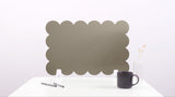 Scalloped headboard on a white background with a mug and pen.