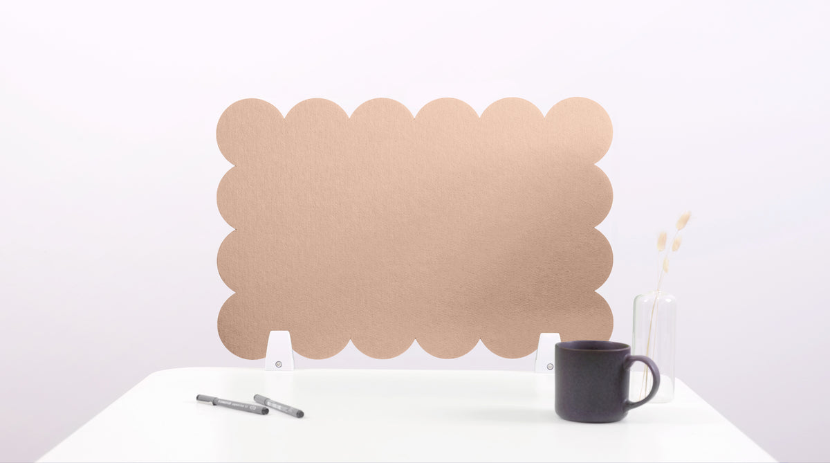 Brown cloud-shaped screen on a white surface with a black mug and pen.