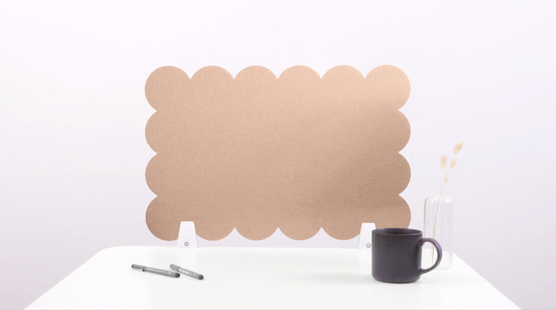 Brown cloud-shaped screen on a white surface with a black mug and pen.