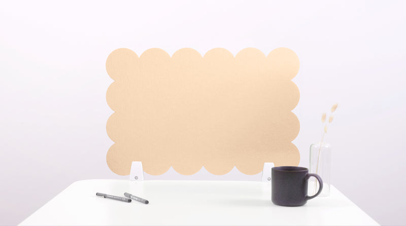Beige cloud-shaped desk organizer on a white surface with a black mug and pen.