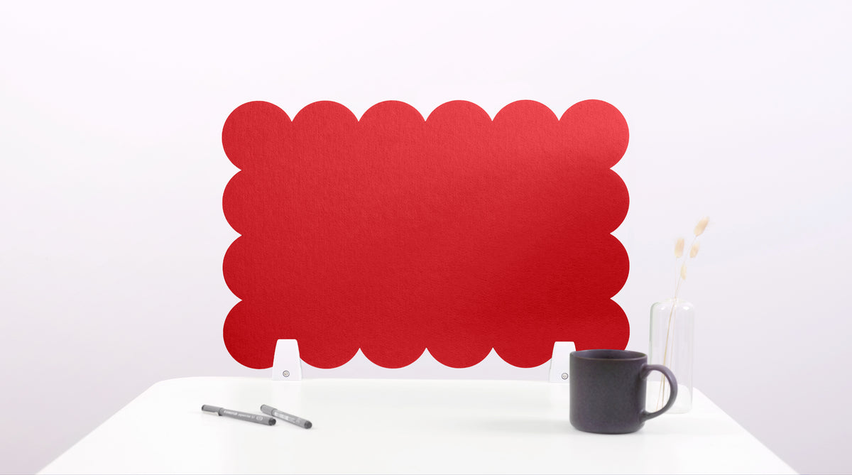Red scalloped office screen on a white background with a black mug and pen.
