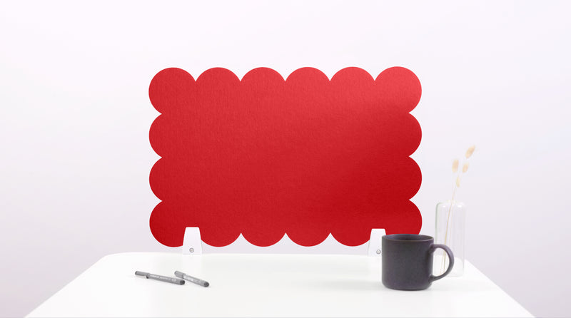 Red scalloped office screen on a white background with a black mug and pen.