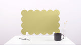 Gold decorative screen on a white surface with a black mug and pen.