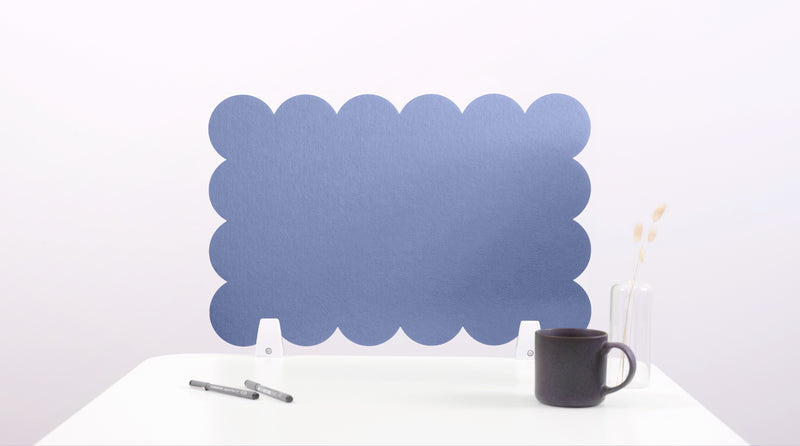 Blue scalloped headboard on a white background with a black mug and pen.