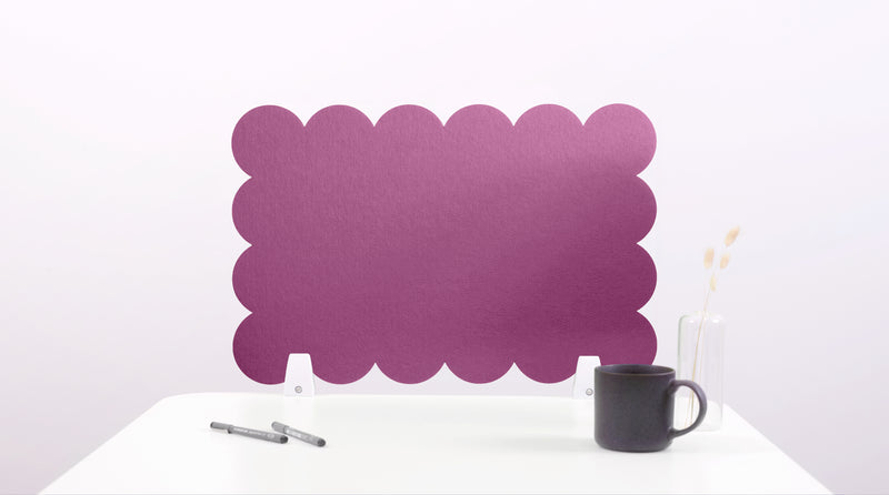 Purple scalloped headboard on a white background with a black mug and pen.