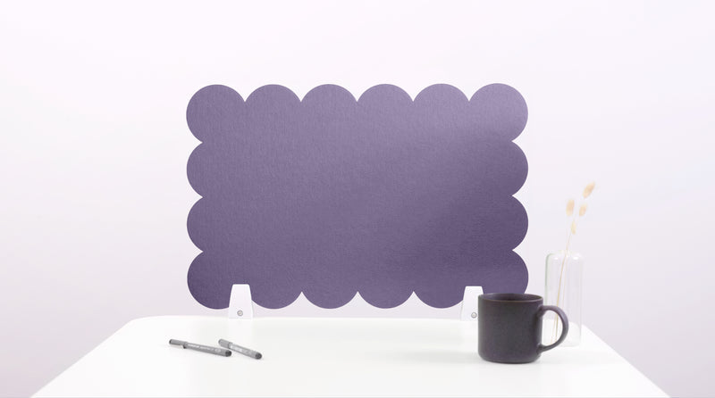 Purple scalloped headboard on a white background with a black mug and pen.