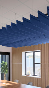 Blue acoustic ceiling blade baffles suspended from the ceiling, installed in a conference room. Felt Right's acoustic blade baffles absorb 65% of sound waves, making office spaces quieter and feel more calm.