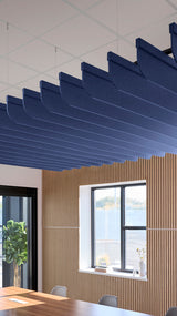 Dark blue acoustic ceiling blade baffles suspended from the ceiling, installed in a conference room. Felt Right's acoustic blade baffles absorb 65% of sound waves, making office spaces quieter and feel more calm.