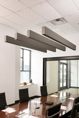Dark wood grain acoustic beams suspended from white drop ceiling in office conference room.