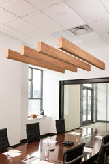 Four wooden beams with grain texture suspended from ceiling in office conference room.