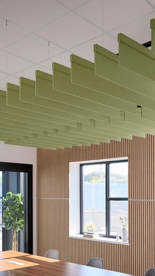 Light green acoustic ceiling blade baffles suspended from the ceiling, installed in a conference room. Felt Right's acoustic blade baffles absorb 65% of sound waves, making office spaces quieter and feel more calm.