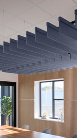 Indigo blue acoustic ceiling blade baffles suspended from the ceiling, installed in a conference room. Felt Right's acoustic blade baffles absorb 65% of sound waves, making office spaces quieter and feel more calm.
