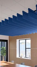 Blue acoustic ceiling blade baffles suspended from the ceiling, installed in a conference room. Felt Right's acoustic blade baffles absorb 65% of sound waves, making office spaces quieter and feel more calm.
