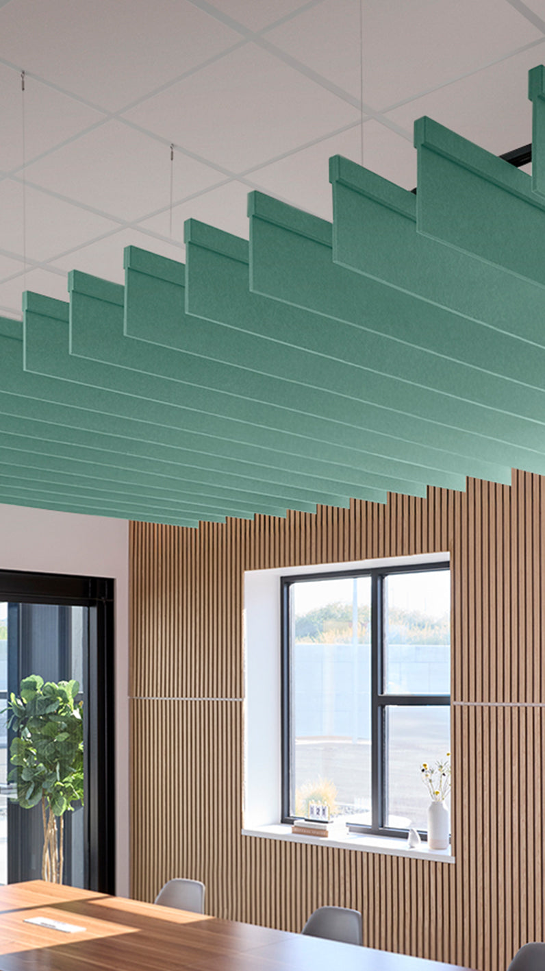 Mint green acoustic ceiling blade baffles suspended from the ceiling, installed in a conference room. Felt Right's acoustic blade baffles absorb 65% of sound waves, making office spaces quieter and feel more calm.