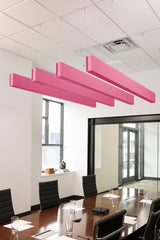 Four pink felt acoustic beams suspended from ceiling in conference room above conference table.