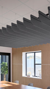 Dark gray curved acoustic baffles suspended from drop ceiling above wooden wall paneling in modern office space.