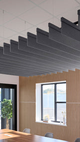 Dark gray acoustic blade baffles suspended horizontally from ceiling above wooden wall paneling and dining area.