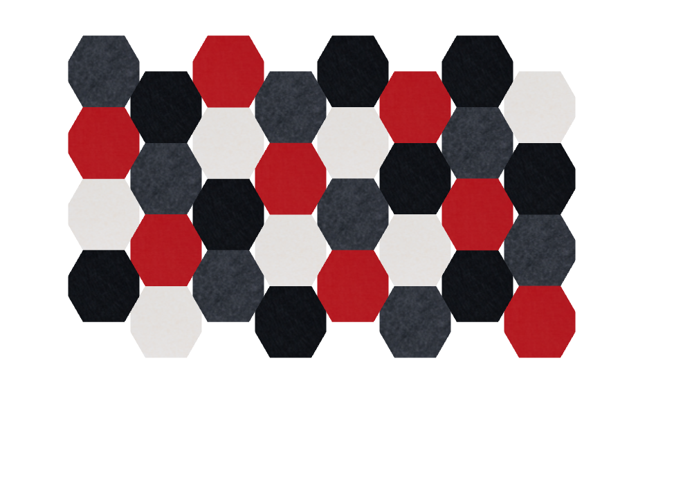 Hexagonal tiles arranged in a honeycomb pattern with red, black, charcoal gray, and cream colored pieces.