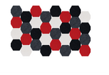 Hexagonal tiles arranged in a honeycomb pattern with red, black, charcoal gray, and cream colored pieces.