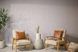 Gray wallpaper alternative PET Felt with vertical wavy line pattern displayed on wall behind two wooden chairs with tan cushions and cognac leather