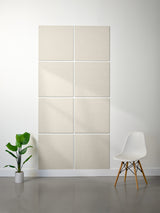 Beige wall panels on a white wall with a white chair and plant in the foreground.