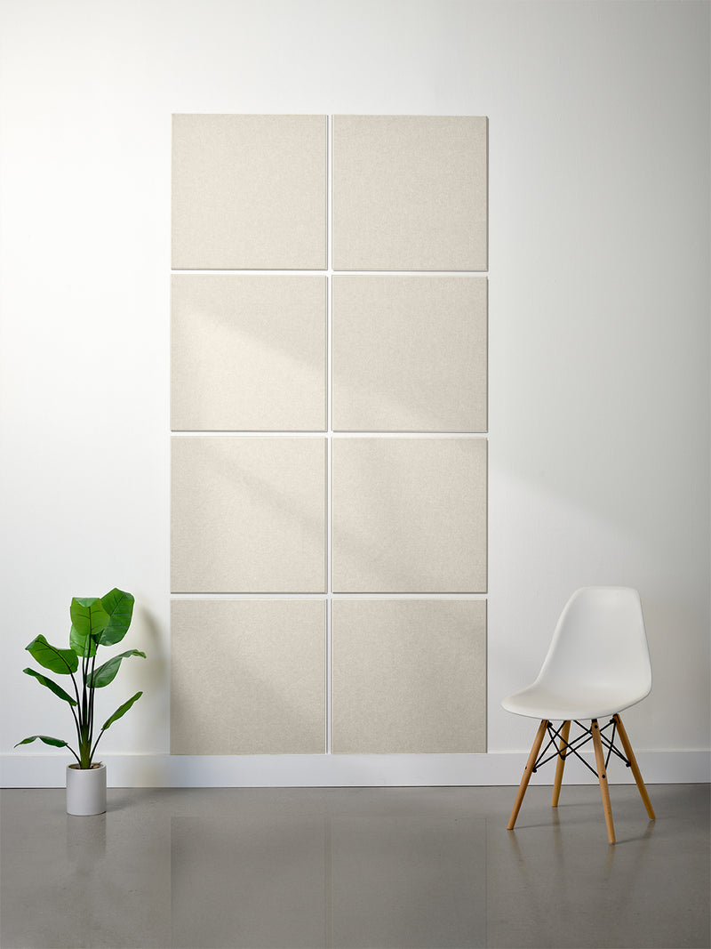 Beige wall panels on a white wall with a white chair and plant in the foreground.