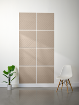 Eight beige tiles with diagonal line engraving arranged in a 2x4 grid on white wall.