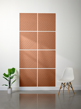 Eight terracotta tiles with diagonal engraved herringbone pattern arranged in a 2x4 grid on white wall.