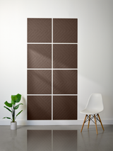 Eight brown tiles arranged in a 2x4 grid, each with engraved diagonal chevron pattern creating a converging geometric design.