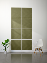 Eight olive-green tiles with engraved chevron pattern arranged in a 2x4 grid on white wall.