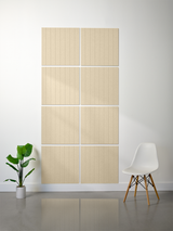 Four beige tiles with vertical engraved parallel lines arranged in a 2x2 grid pattern on a wall.