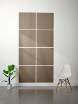 Eight tan tiles with vertical engraved parallel lines arranged in a 2x4 grid on a wall.
