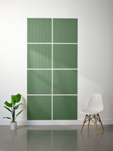 Green tiles with vertical parallel line engravings arranged in a 2x4 grid on a wall.