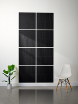 Eight black rectangular tiles with engraved vertical line pattern arranged in offset grid layout on wall.