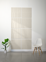 Four beige rectangular tiles with vertical engraved line pattern arranged in offset rows on white wall.
